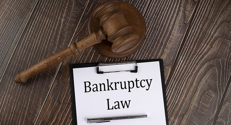 bankruptcy law written on pad with gavel