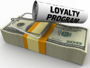 bundle of money with mouse trap on top and words loyalty program loyalty traps
