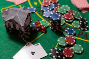 casino table chips and cards with house on top of chips