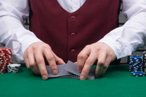 croupier shuffling decks of cards