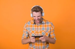 excited listening using headphones playing games on phone