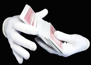 gloved handing sorting playing cards