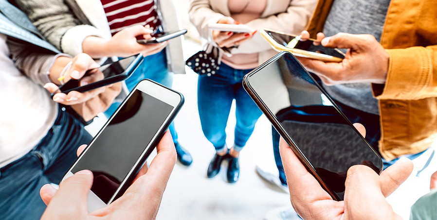 group of friends in circle with smartphones gambling