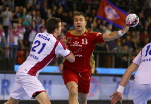 handball player reaches for the ball