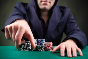 poker player adding chips to the pot