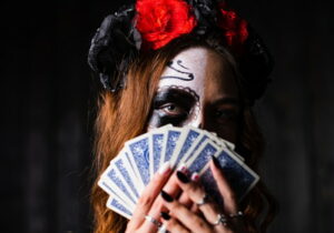 scary woman holding playing cards